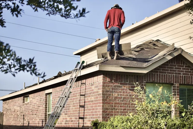 Professional roofer working on a residential roof in Farmington Road Estates